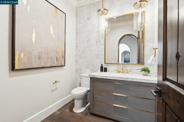 a dining room with furniture a fireplace and wooden floor