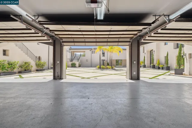 a living room with patio furniture and a floor to ceiling window