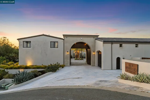 a living room with furniture a table and a large window