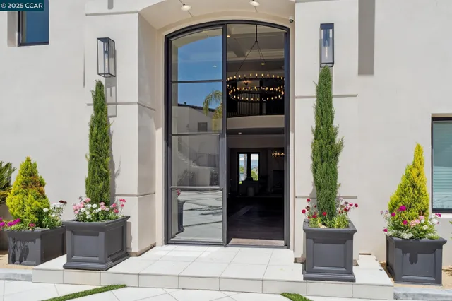 a room with kitchen island stainless steel appliances a sink and a window