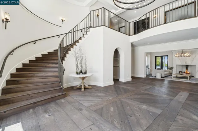 a living room with furniture a flat screen tv and a floor to ceiling window