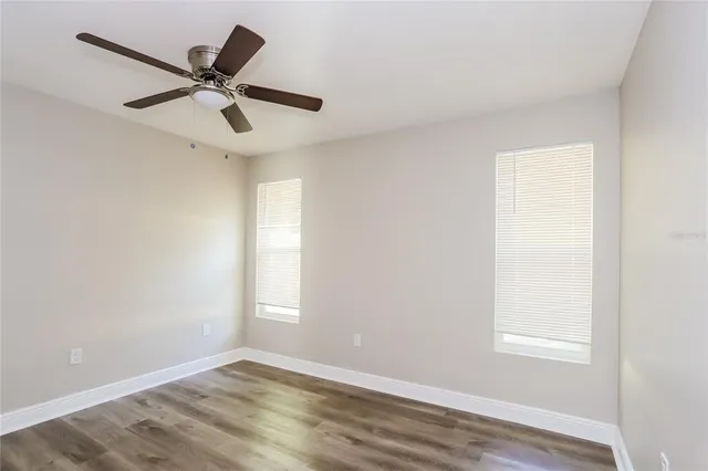 a view of a ceiling fan and wooden floor