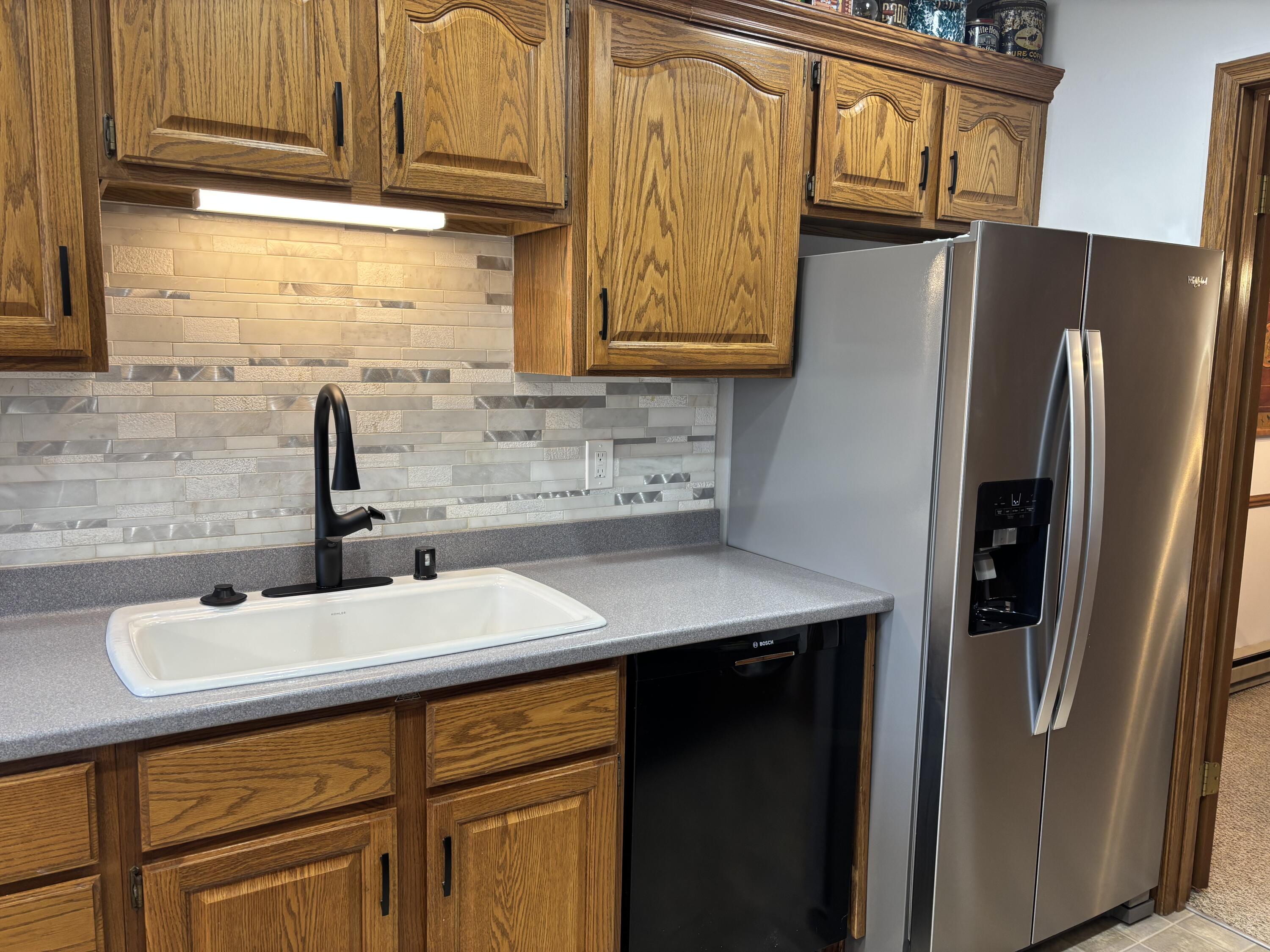 5810 Ring Neck Terrace, Unit 204 Mount Pleasant, WI 53406 - Photo 8 of 33 New Kohler farmhouse sink and faucet, new Bosch dishwasher, new SS refrigerator.