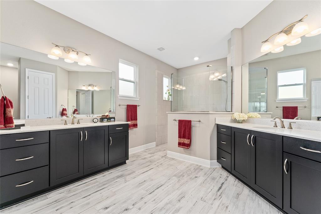 8290 Southwest 92nd Circle Ocala, FL 34481 - Photo 15 of 46 a large bathroom with a sink vanity granite tub and a mirror