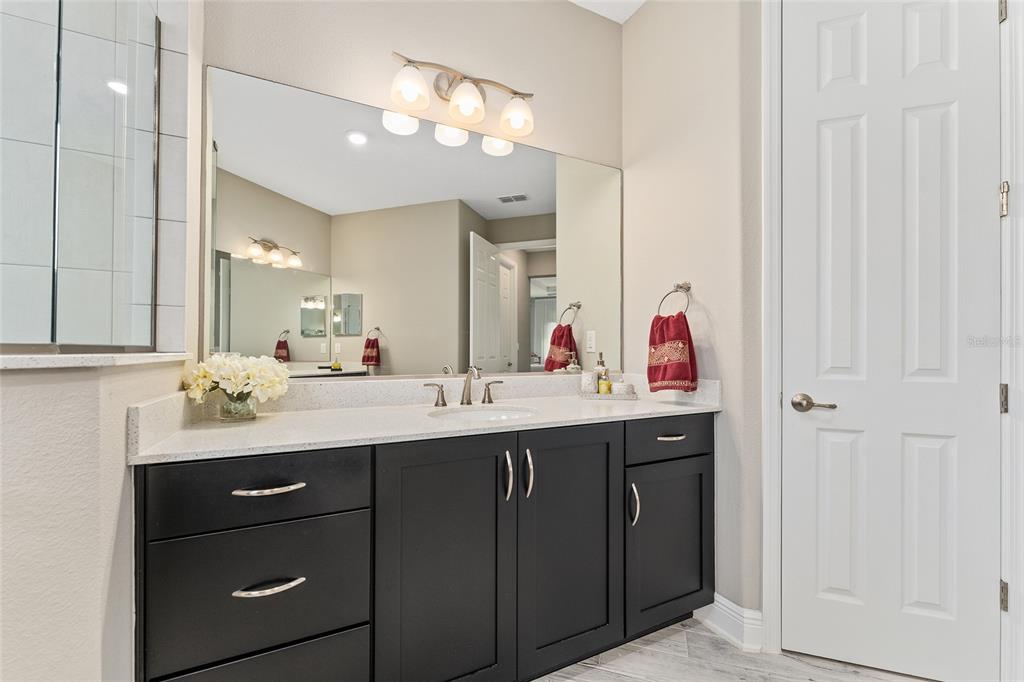 8290 Southwest 92nd Circle Ocala, FL 34481 - Photo 18 of 46 a bathroom with a double vanity sink and a mirror