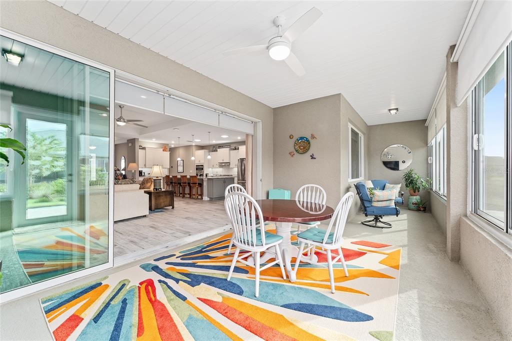 8290 Southwest 92nd Circle Ocala, FL 34481 - Photo 23 of 46 a living room with furniture a rug and a chandelier