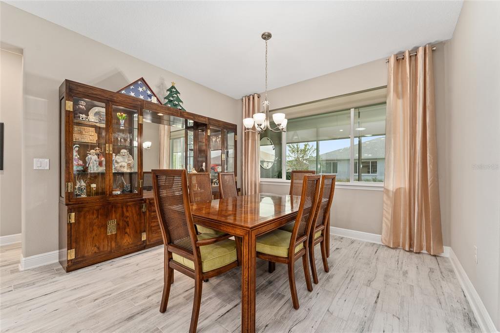 8290 Southwest 92nd Circle Ocala, FL 34481 - Photo 24 of 46 a dining room with furniture window and wooden floor