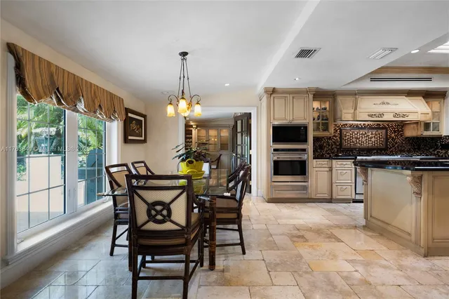 a living room with furniture potted plant floor to ceiling window and a flat screen tv