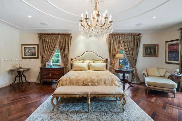 a spacious bedroom with a bed and a flat screen tv