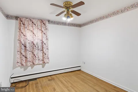 a view of a hallway with a window and a ceiling fan