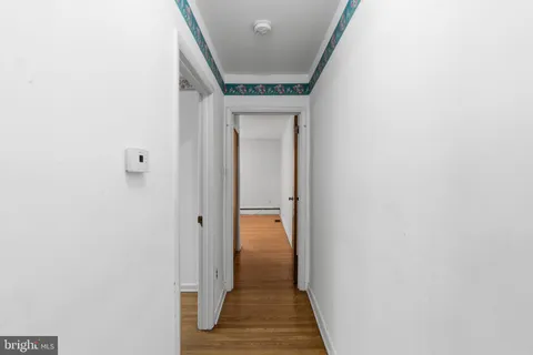 a view of hallway with wooden floor