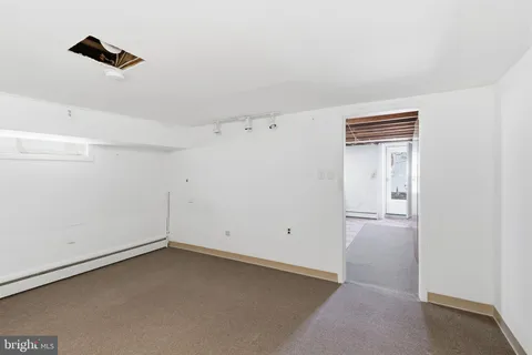 an empty room with closet and windows