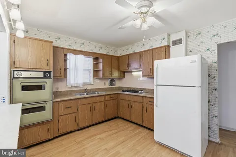 a kitchen with stainless steel appliances a refrigerator sink and microwave