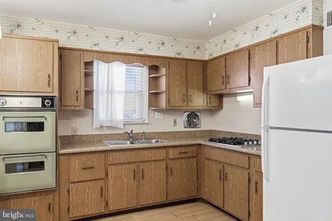 a kitchen with stainless steel appliances granite countertop a refrigerator sink and cabinets