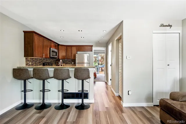 a kitchen with stainless steel appliances a stove a refrigerator and cabinets