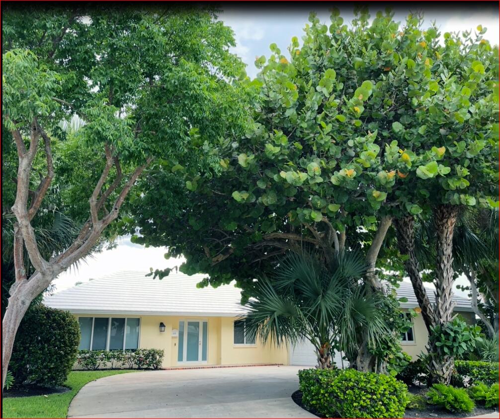 610 Juneberry Court Boca Raton, FL 33486 - Photo 1 of 11 a front view of a house with a garden