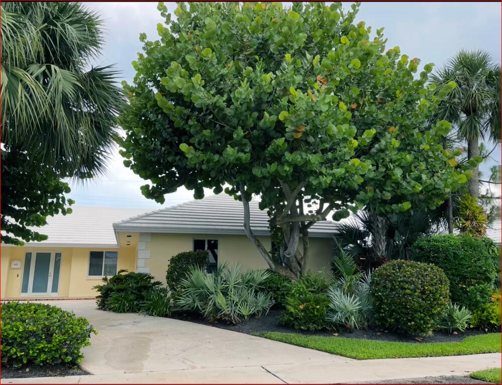 610 Juneberry Court Boca Raton, FL 33486 - Photo 2 of 11 a front view of a house with garden