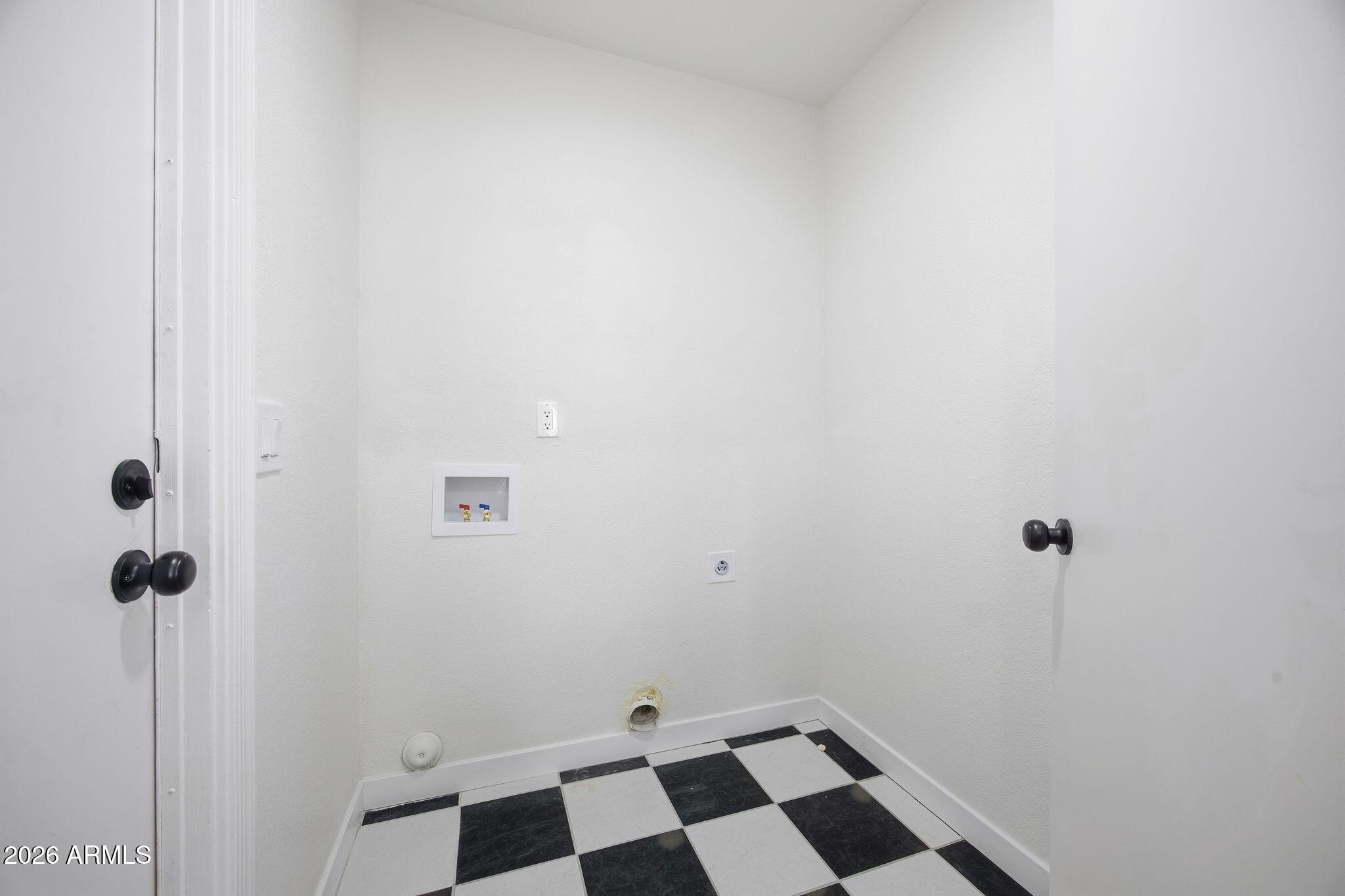 3134 East McKellips Road, Unit 69 Mesa, AZ 85213 - Photo 21 of 24 a bathroom with a black and white checkered floor