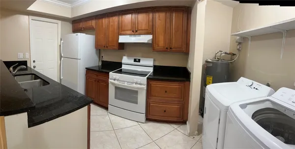 a kitchen with a stove sink and a refrigerator
