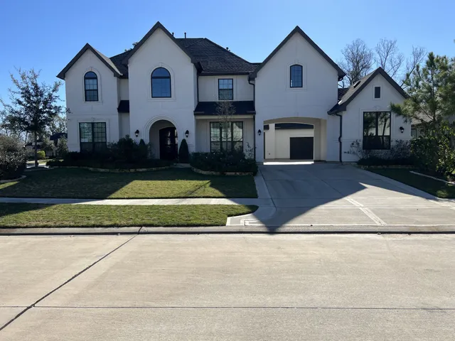 a view of house with outdoor space and view of a house