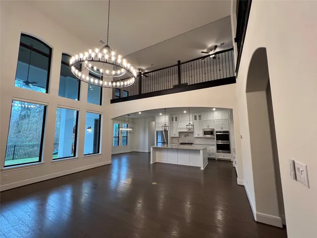 a view of a hallway with wooden floor and stairs