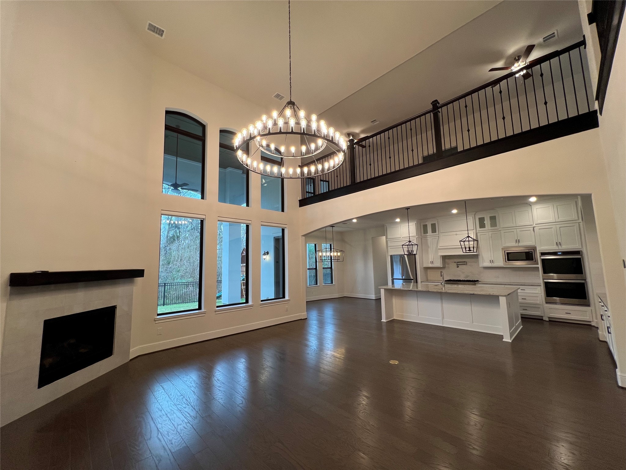 8526 Tombron Grove Road Magnolia, TX 77354 - Photo 13 of 20 a view of a room with chandelier and wooden floor