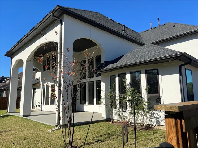 a view of a house with backyard porch and furniture