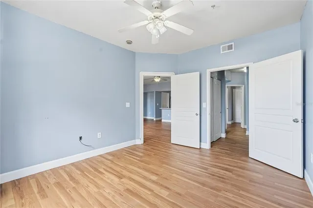 a view of a hallway and wooden floor in a kitchen