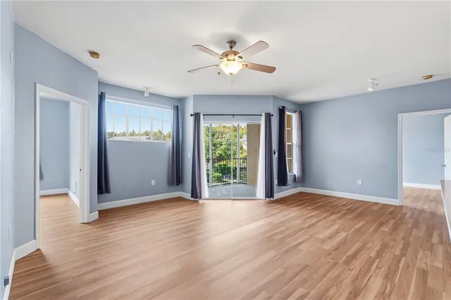 a kitchen with white cabinets and sink