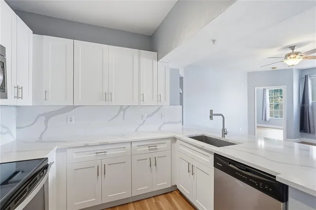 a view with granite countertop a sink and a window