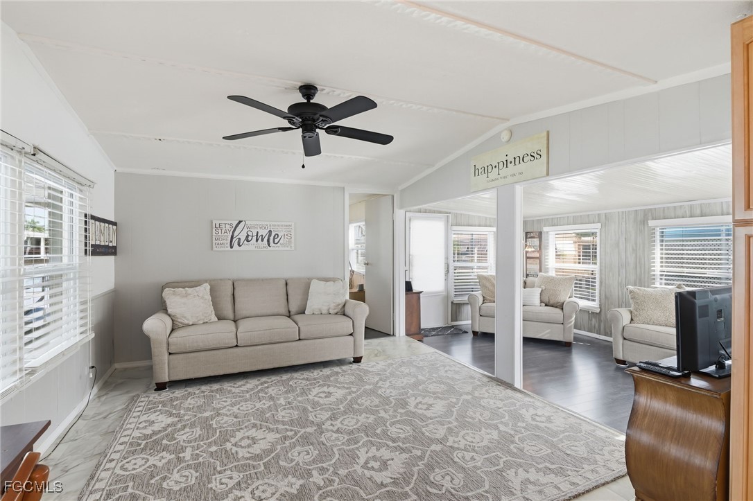 24 Cheyenne Trail, Unit 167 Naples, FL 34113 - Photo 11 of 27 a living room with furniture and a flat screen tv