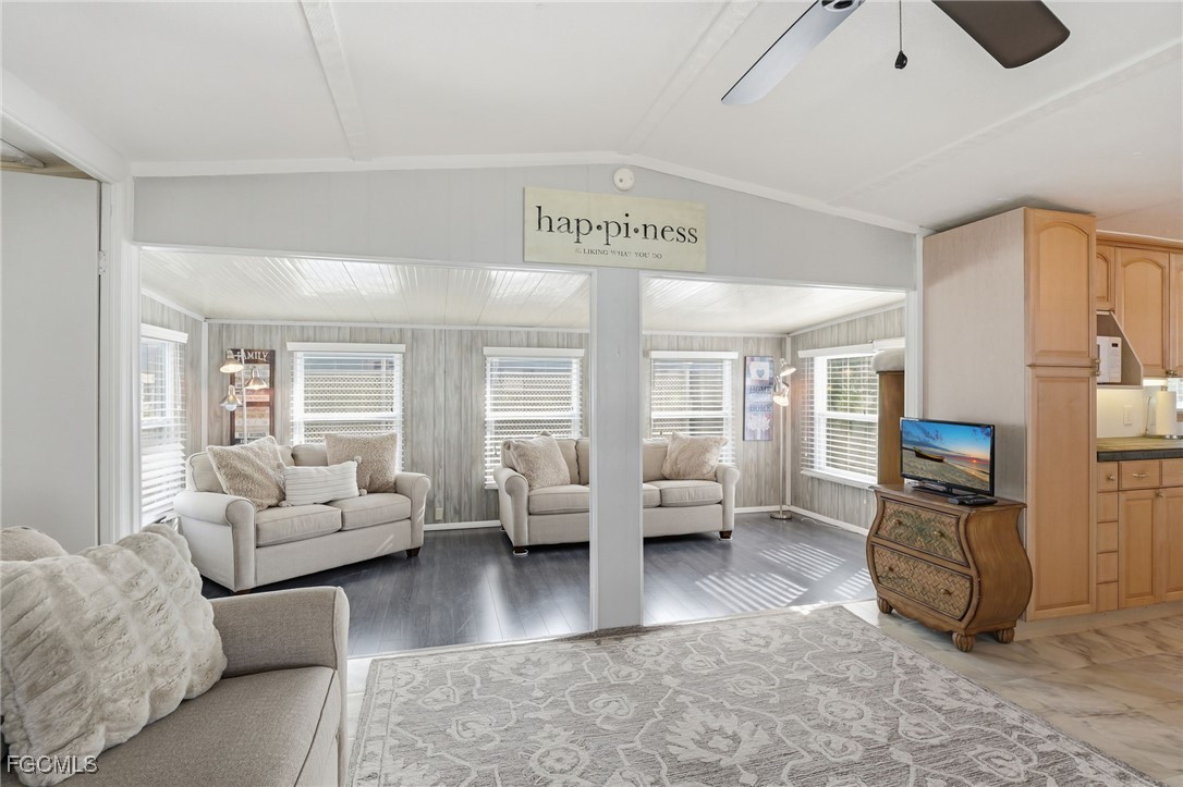 24 Cheyenne Trail, Unit 167 Naples, FL 34113 - Photo 13 of 27 a living room with furniture and a flat screen tv