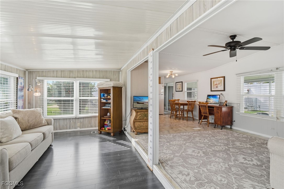 24 Cheyenne Trail, Unit 167 Naples, FL 34113 - Photo 16 of 27 a living room with furniture and a large window
