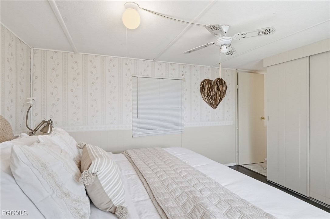 24 Cheyenne Trail, Unit 167 Naples, FL 34113 - Photo 19 of 27 a bedroom with a bed and a chandelier