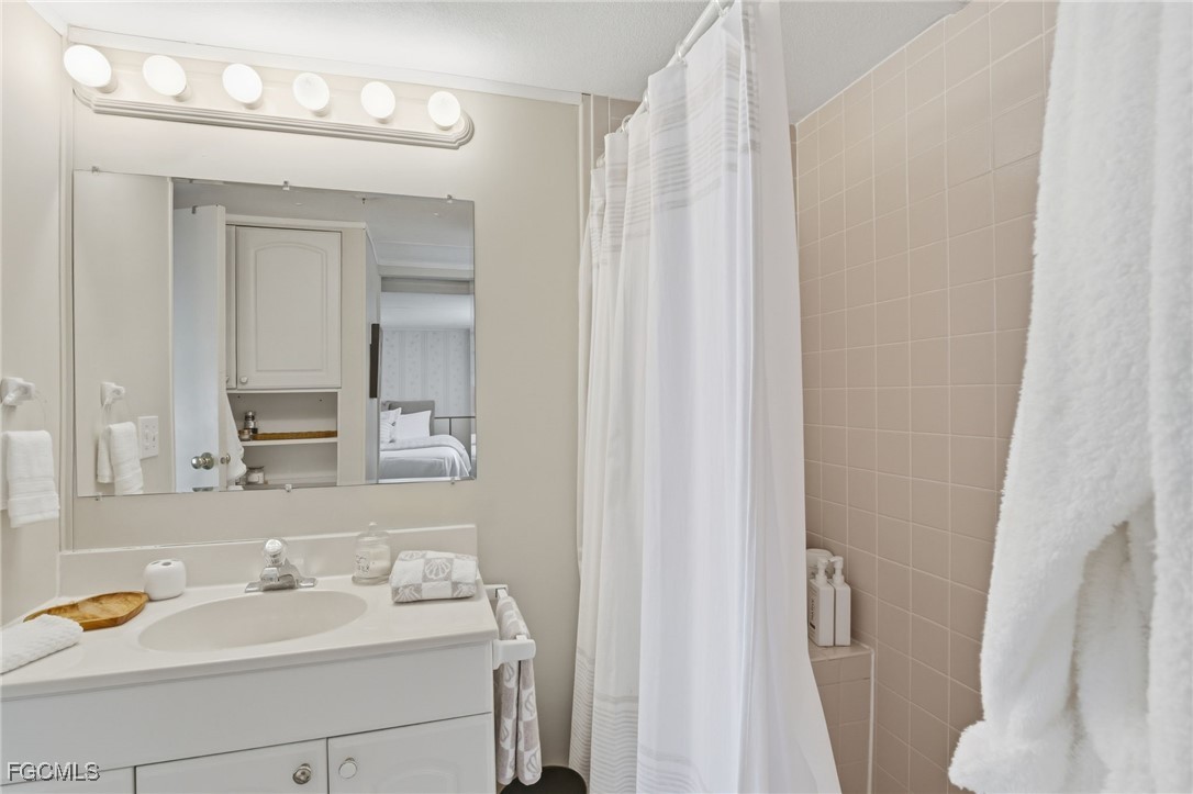 24 Cheyenne Trail, Unit 167 Naples, FL 34113 - Photo 21 of 27 a bathroom with a sink and a mirror