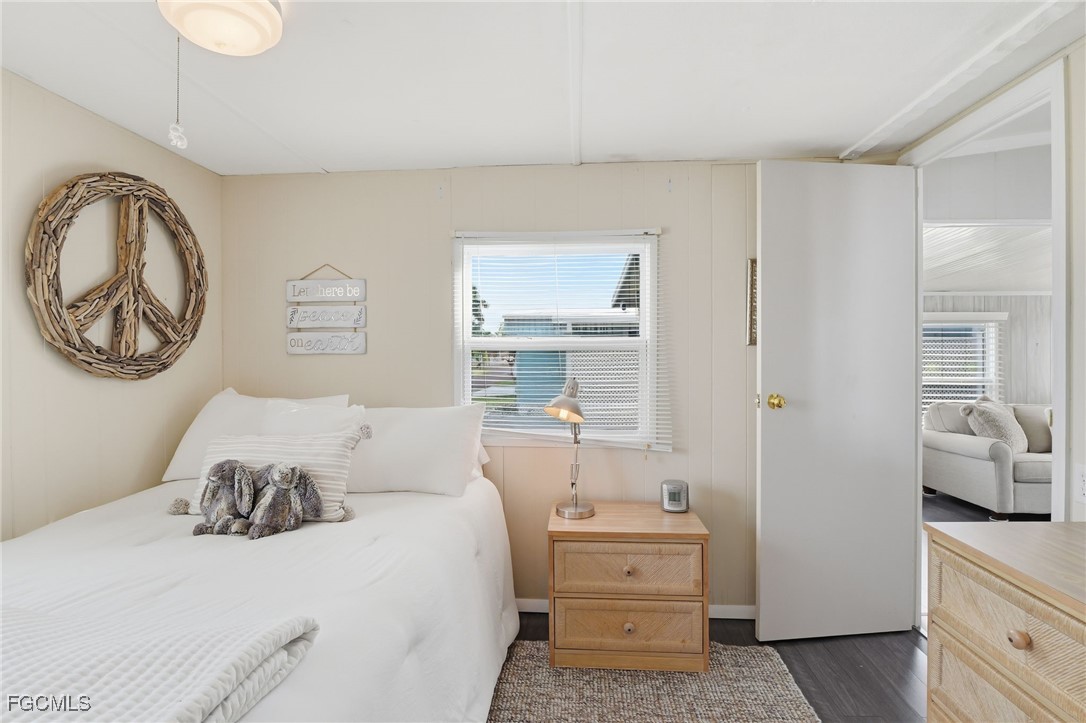 24 Cheyenne Trail, Unit 167 Naples, FL 34113 - Photo 23 of 27 a bedroom with a bed and a chandelier