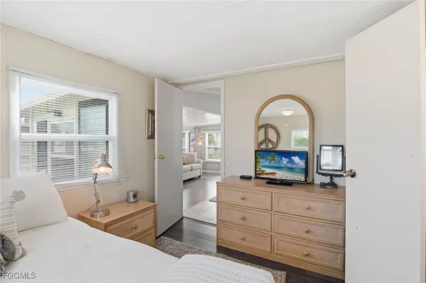 a living room with furniture windows and a flat screen tv