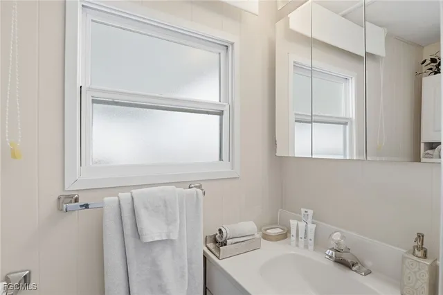 a bathroom with a sink vanity and mirror