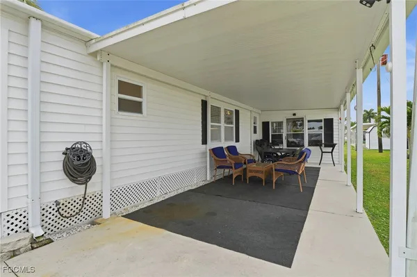 a view of a patio with table and chairs