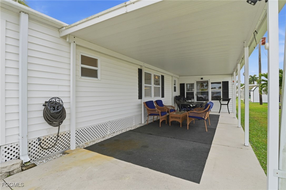 24 Cheyenne Trail, Unit 167 Naples, FL 34113 - Photo 3 of 27 a view of a patio with table and chairs