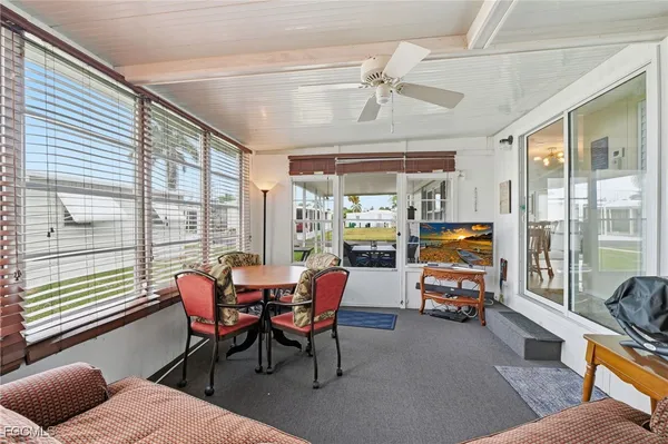 a view of a livingroom with furniture and a large window