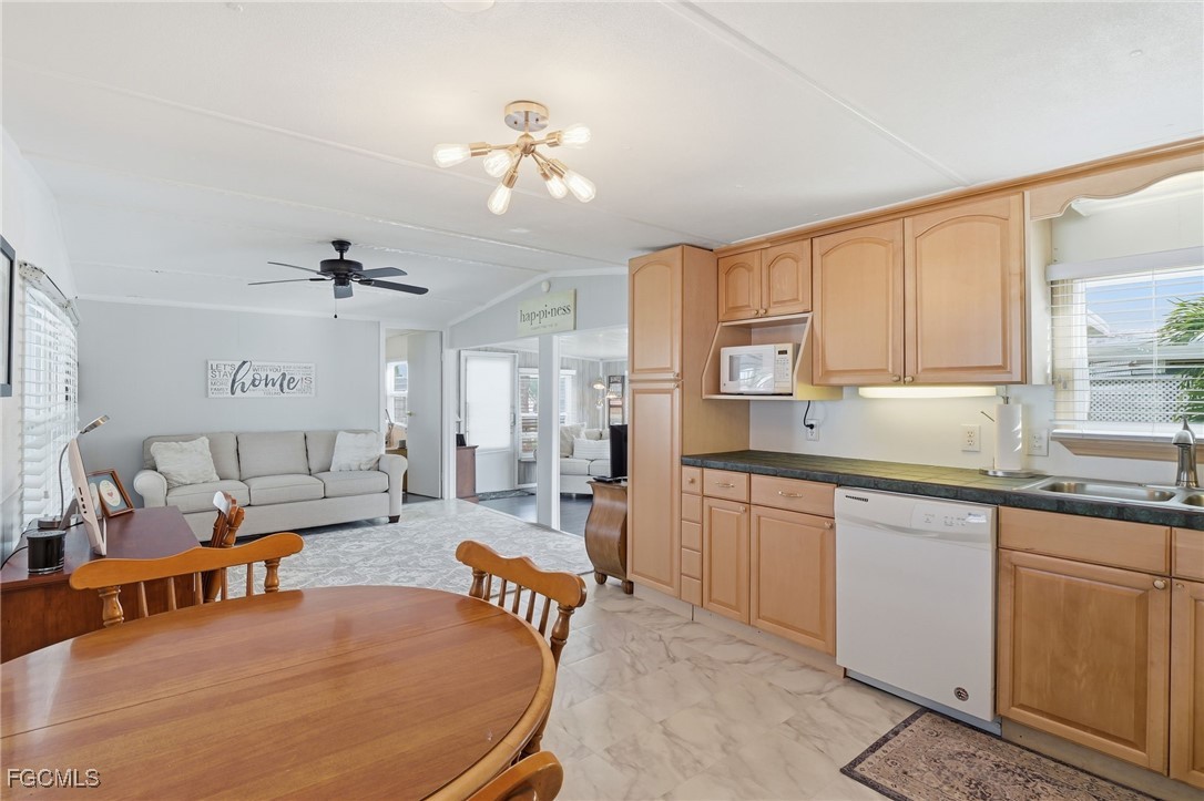 24 Cheyenne Trail, Unit 167 Naples, FL 34113 - Photo 7 of 27 a large living room with stainless steel appliances kitchen island granite countertop furniture and a kitchen view