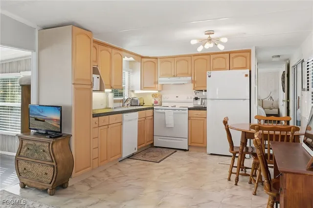 a kitchen with a sink appliances and cabinets