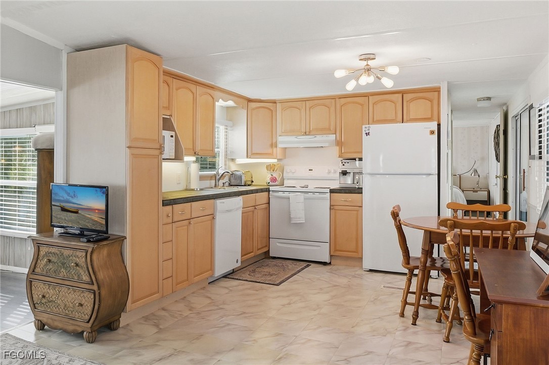24 Cheyenne Trail, Unit 167 Naples, FL 34113 - Photo 8 of 27 a kitchen with a sink appliances and cabinets