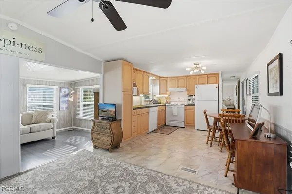 a living room with furniture and kitchen view