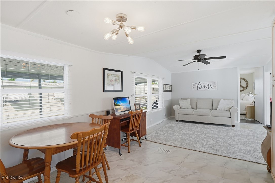 24 Cheyenne Trail, Unit 167 Naples, FL 34113 - Photo 10 of 27 a living room with furniture a chandelier and a window