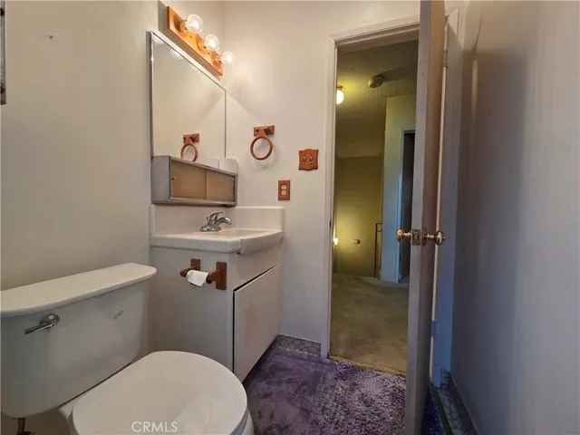 an empty room with closet and a chandelier fan