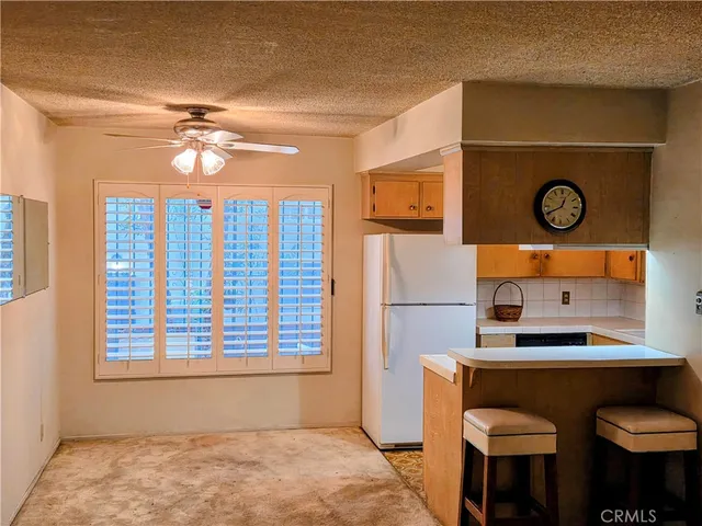 a kitchen with refrigerator and window
