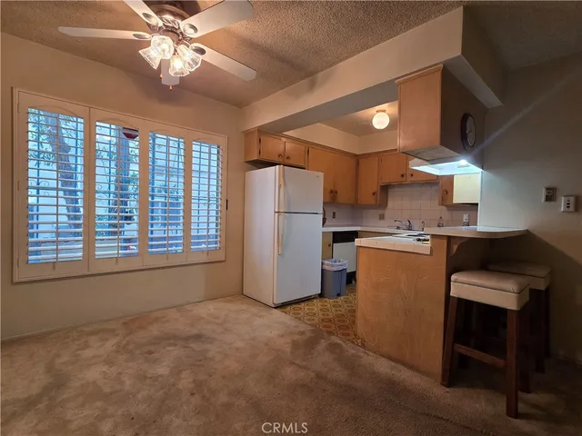 a kitchen with a refrigerator and a sink