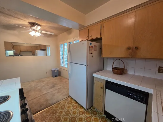 a kitchen with a white cabinets and white appliances
